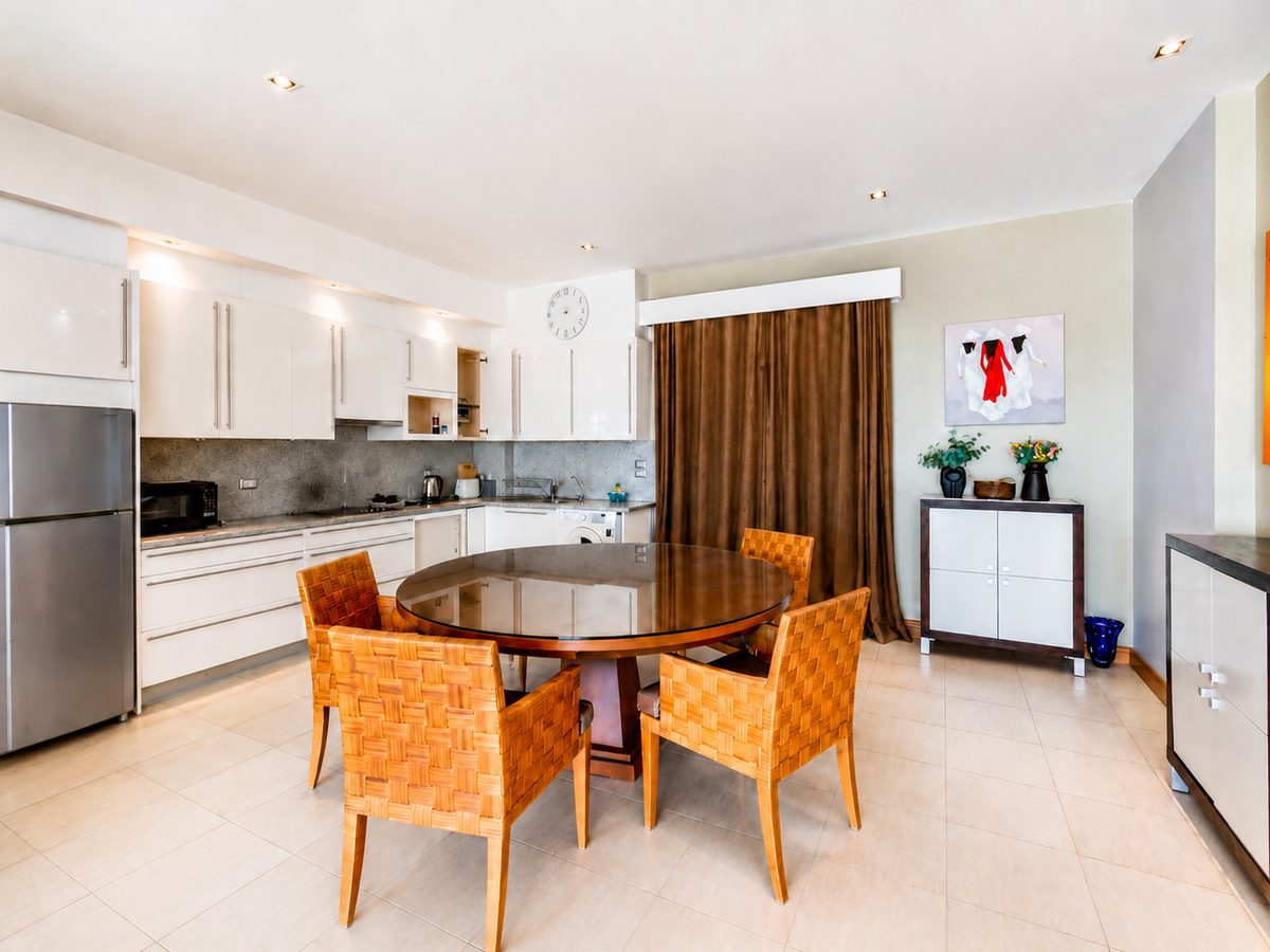 White gloss kitchen with round dining table
