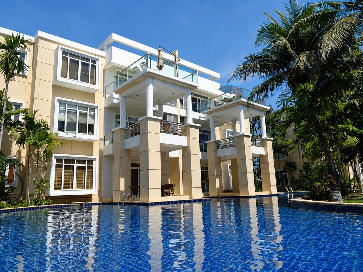 The lagoon pool curving between tropical gardens and the residence buildings