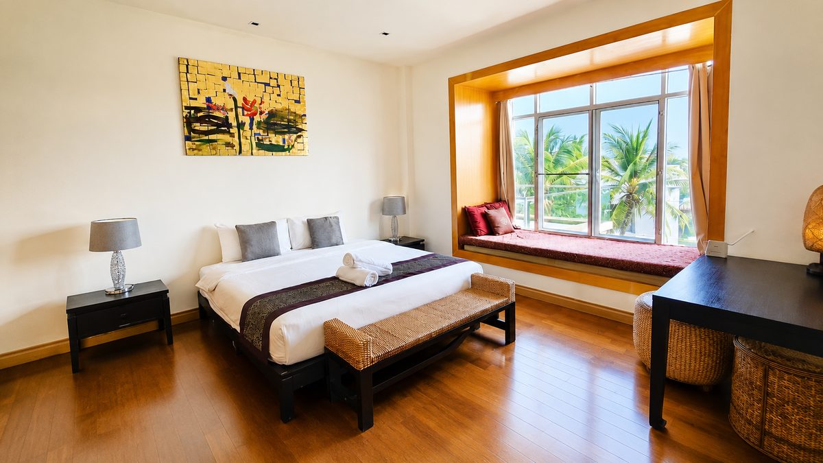 Master bedroom with bay window seat and palm view