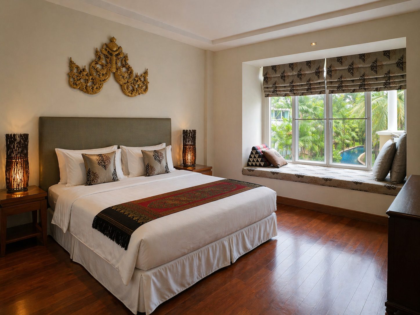 Master bedroom with a bay-window day bed framing the pool outside