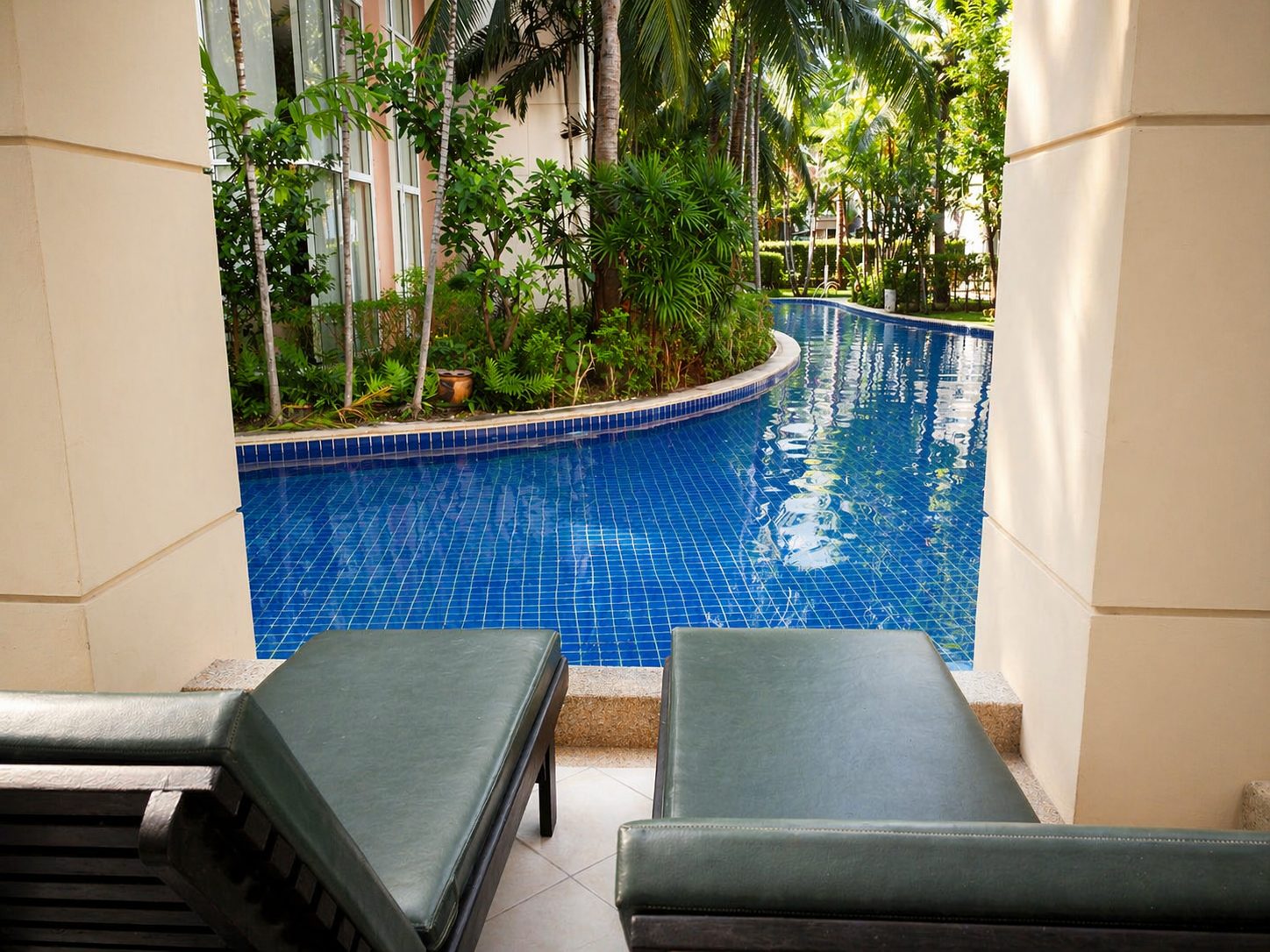 Private terrace with sun loungers looking straight onto the lagoon pool